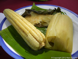 Cob corn, sweet corn bread and corn tamale served on a banana leaf