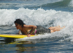Peggy rides a wave at Playa Las Flores, El Cuco