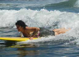 Peggy rides a wave at Playa Las Flores, El Cuco