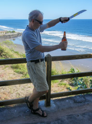 Marc opening a bottle of beer with his new machete in El Cuco
